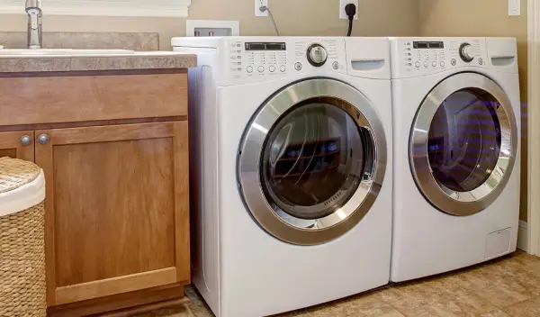 Laundry room with a white front-load washer and dryer set.