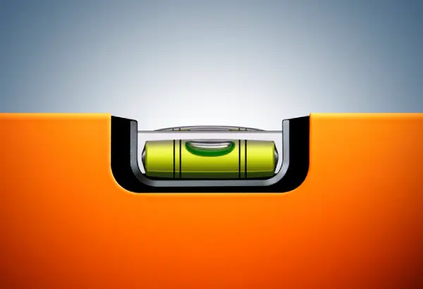 Carpenter's level used to level a washing machine.