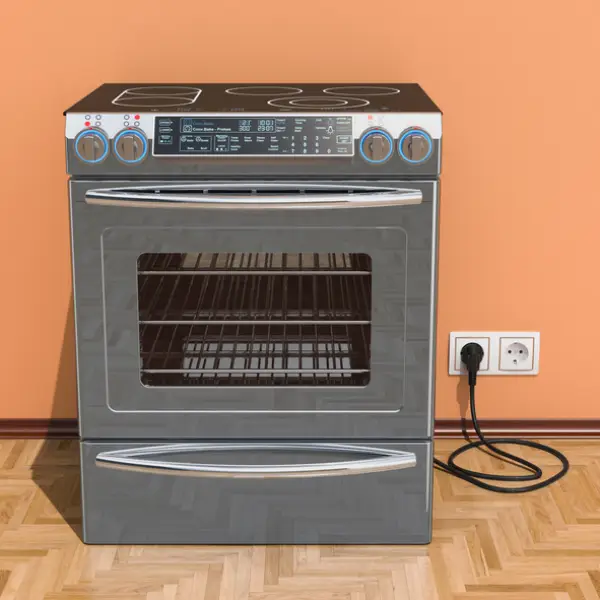 Stainless steel oven range plugged into an electrical outlet.