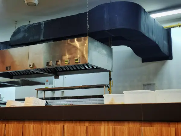 Ducted vent hood system in a commercial kitchen.